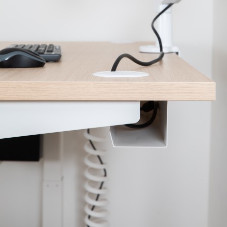 Organisateur range-câbles métallique noir fixé sous un bureau